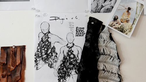 Jennifer Irwin's sketches of dingoes costumes are pinned to a wall alongside fabric samples for Red Mallee and the skirts worn in Birds.