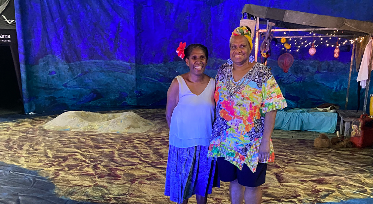 Performer Elma Kris stands with Language Consultant Leonora Adidi on the set of Waru in the sports complex on Thursday Island.